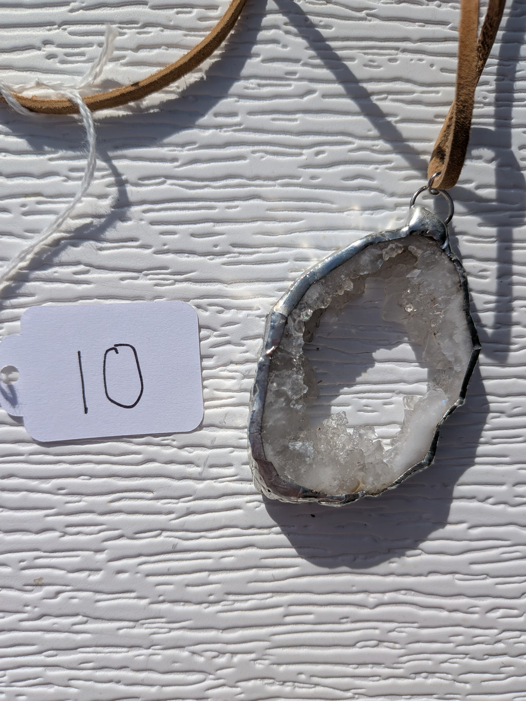 Back of Open Sky geode necklace No. 010, showing the natural stone contours and handmade silver-tone edge.
