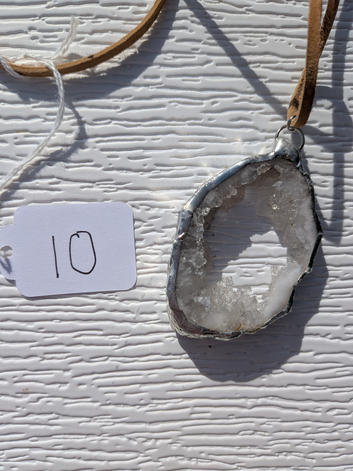 Back of Open Sky geode necklace No. 010, showing the natural stone contours and handmade silver-tone edge.
