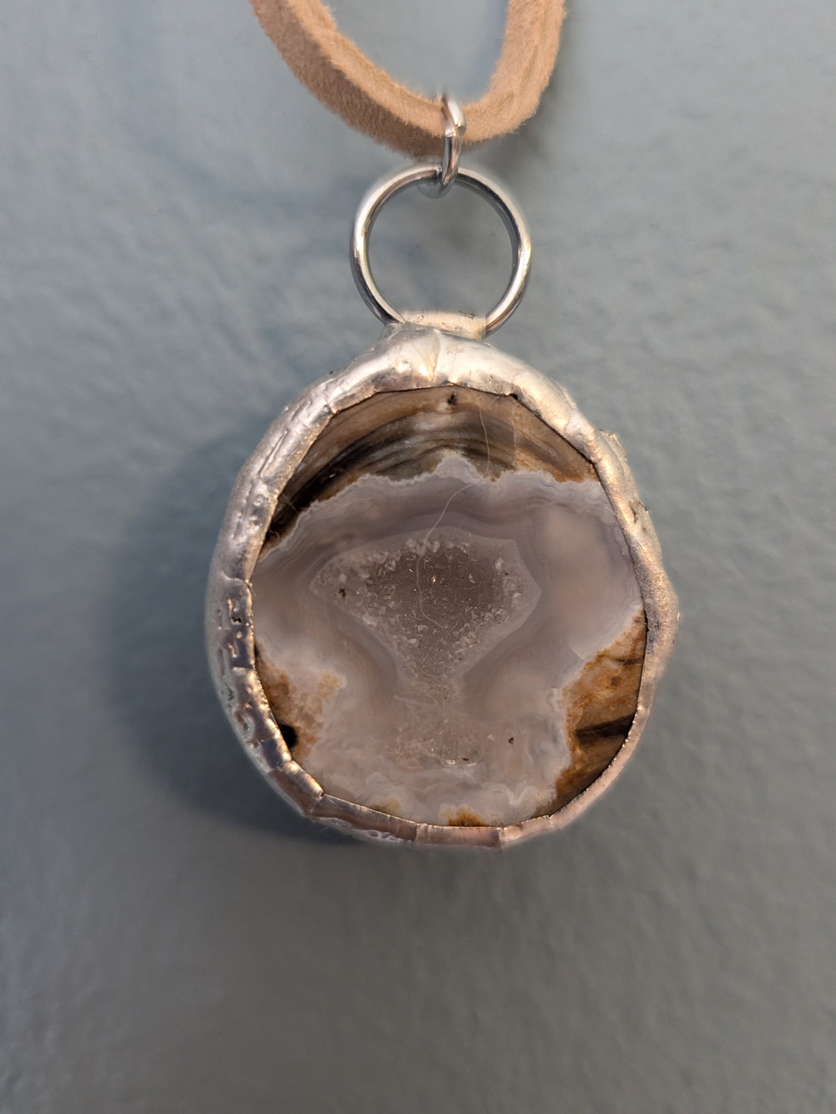 Necklace No. 011: front close-up of the blue agate, natural stone detail and handmade silver-tone edging.