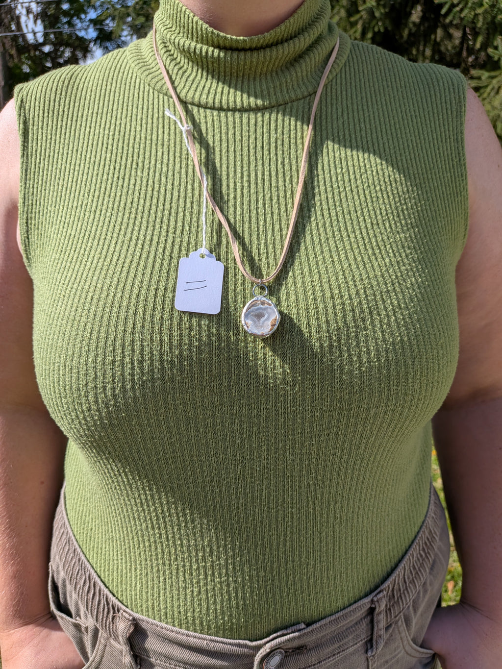 Silver Mist Banded necklace No. 011 worn on the body, showing the pendant's proportions and tan cord.