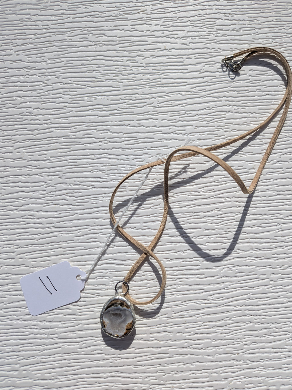 Full Silver Mist Banded necklace No. 011, showing the pendant, tan cord, and clasp.