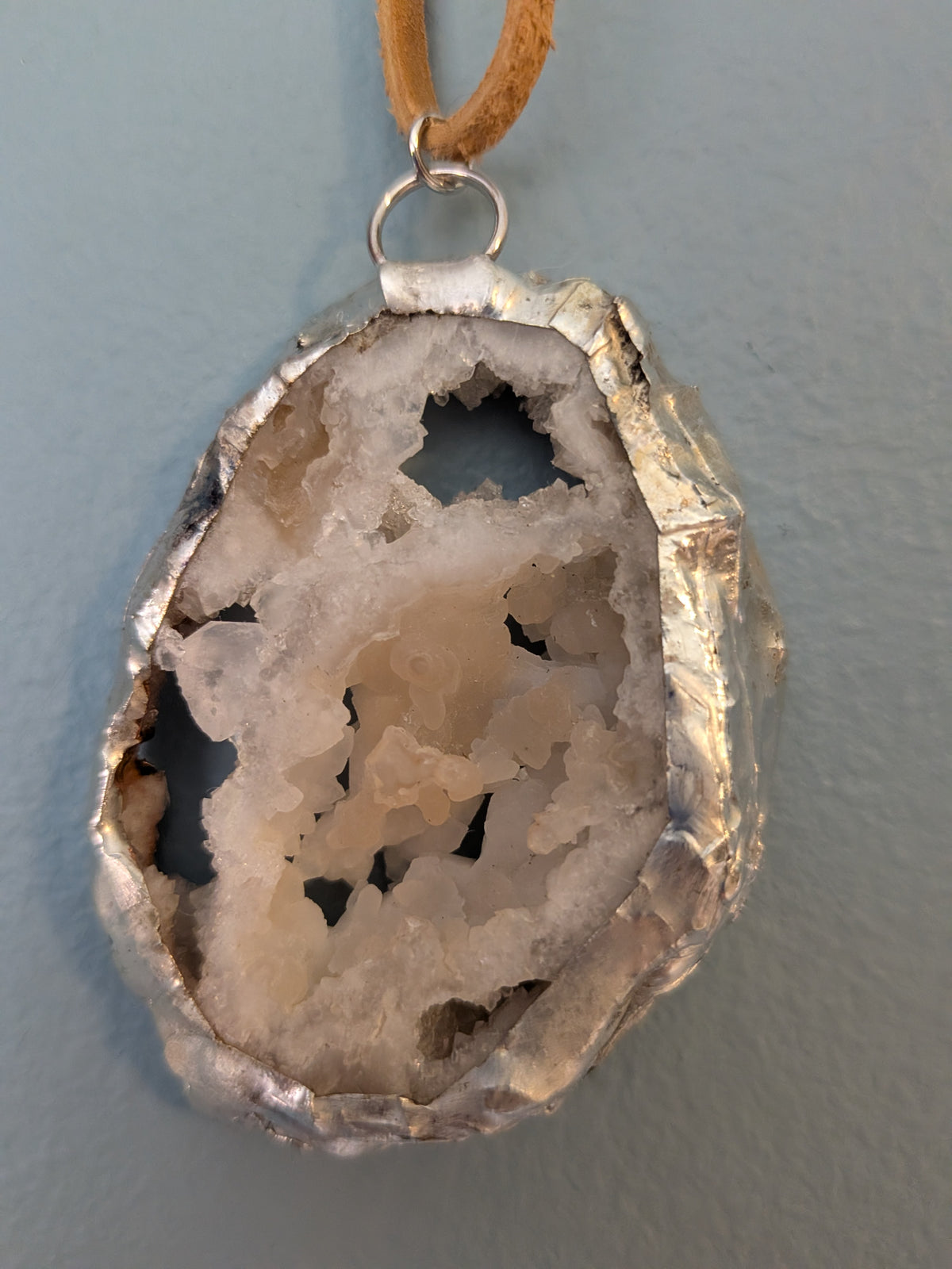 Necklace No. 012: front close-up of the cream geode, natural stone detail and handmade silver-tone edging.