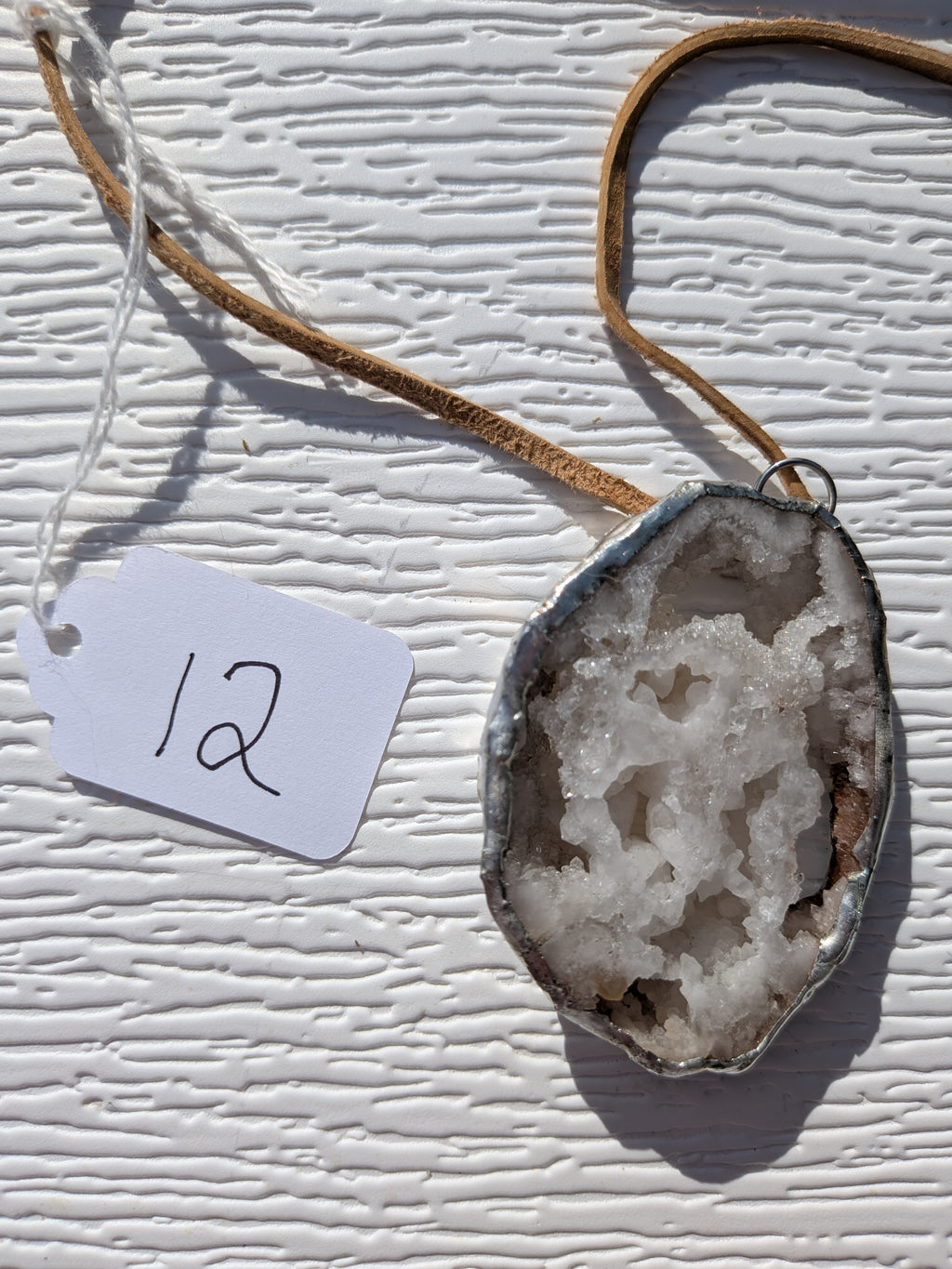 Back of Honey Crystal Cavern geode necklace No. 012, showing the natural stone contours and handmade silver-tone edge.