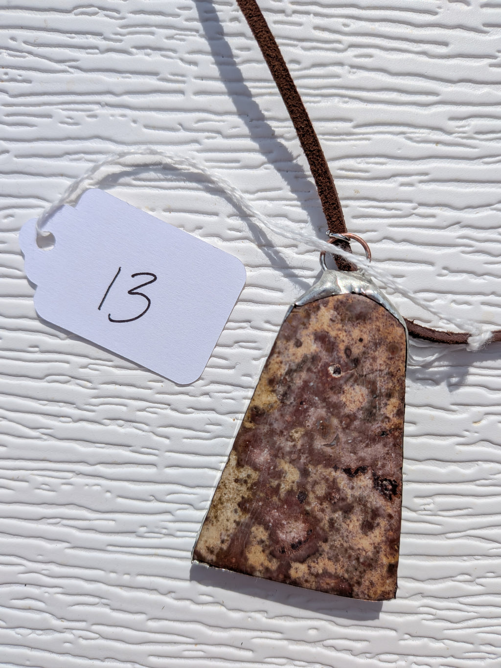 Back of Earth Mosaic necklace No. 013, showing the natural stone contours and handmade silver-tone edge.
