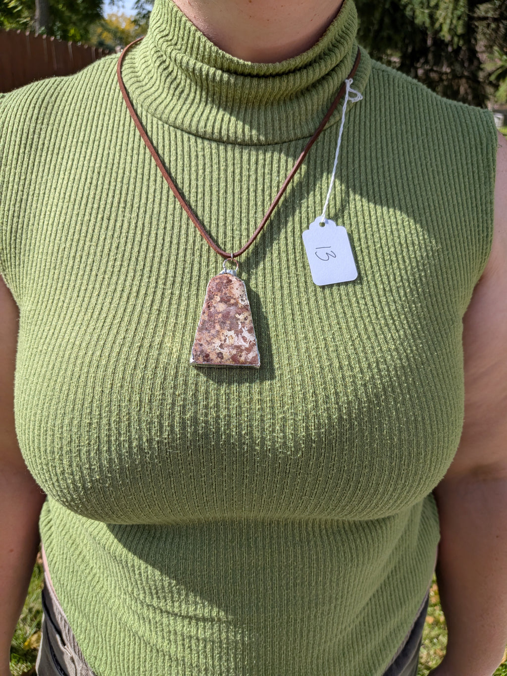 Earth Mosaic necklace No. 013 worn on the body, showing the pendant's proportions and dark brown cord.