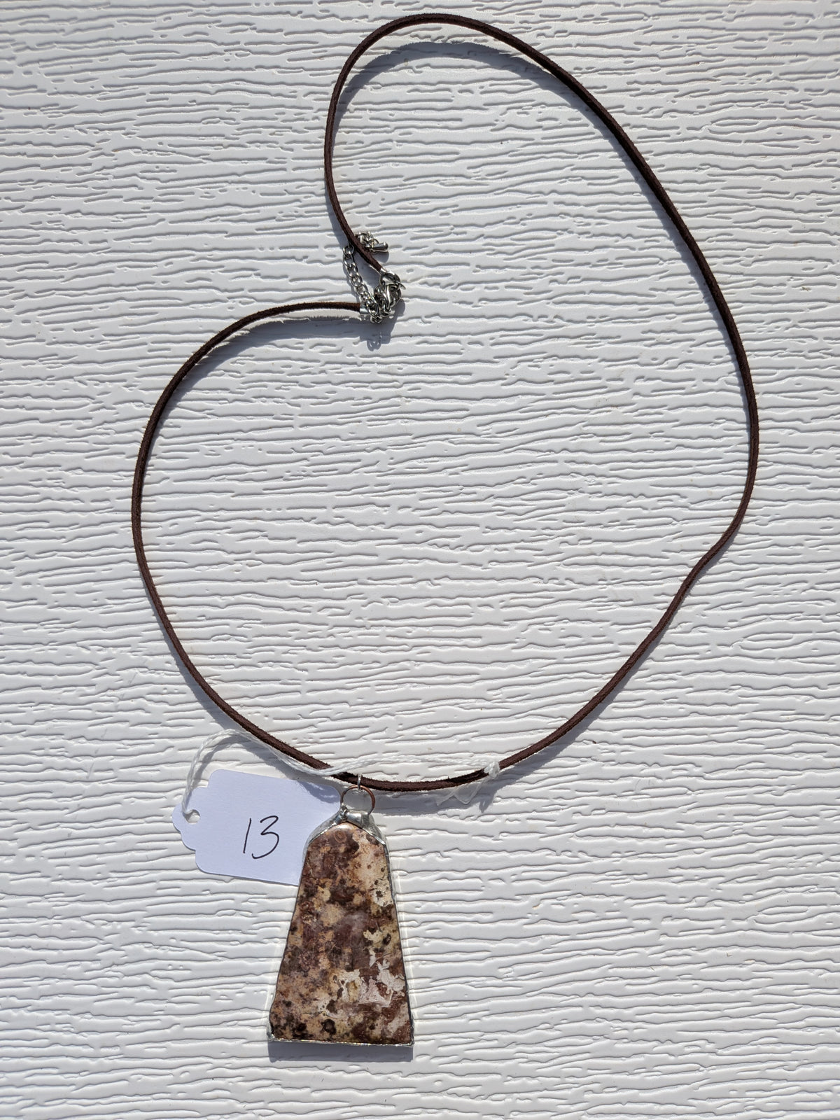 Full Earth Mosaic necklace No. 013, showing the pendant, dark brown cord, and clasp.