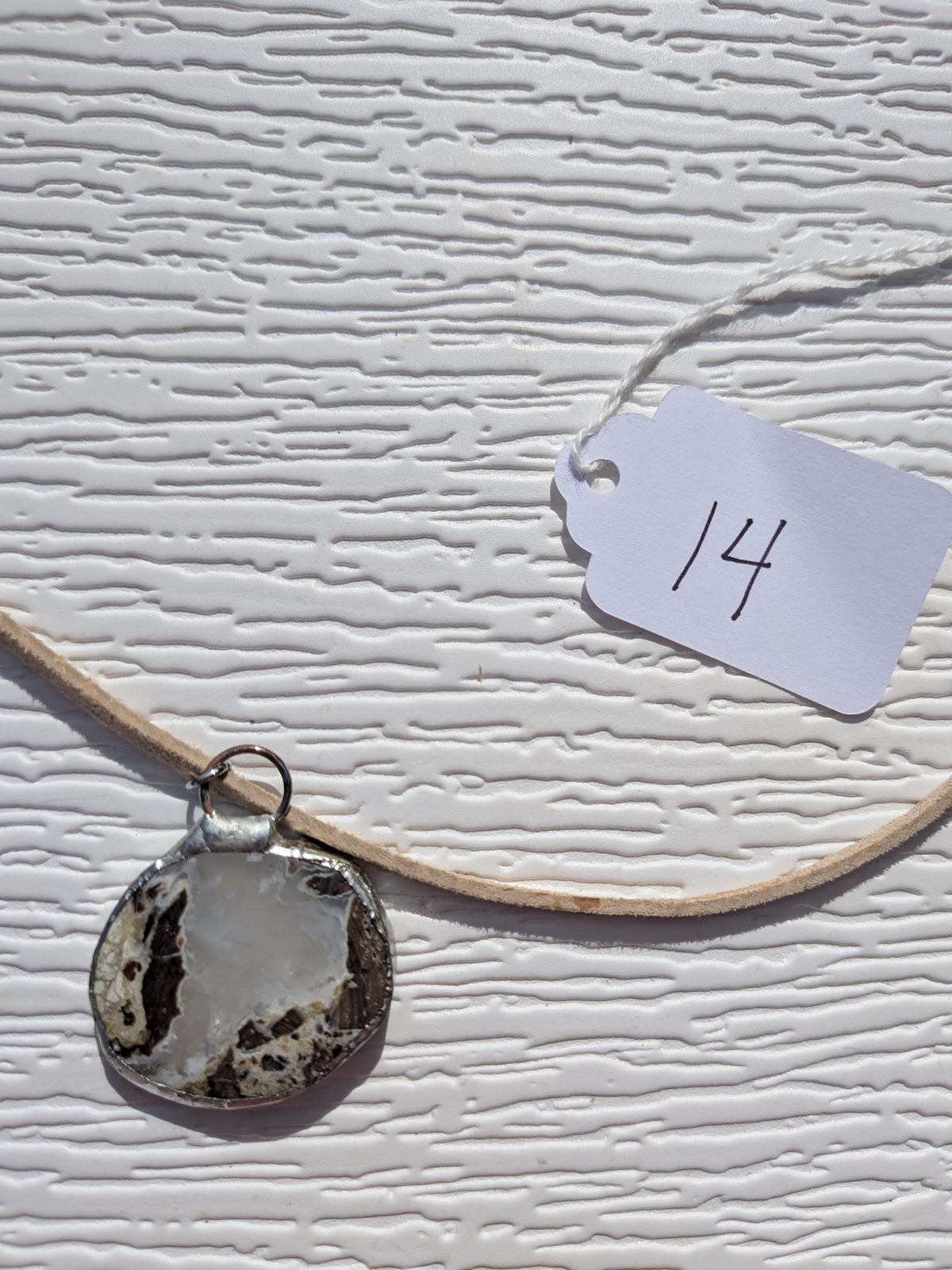 Back of Cloud Meadow necklace No. 014, showing the natural stone contours and handmade silver-tone edge.