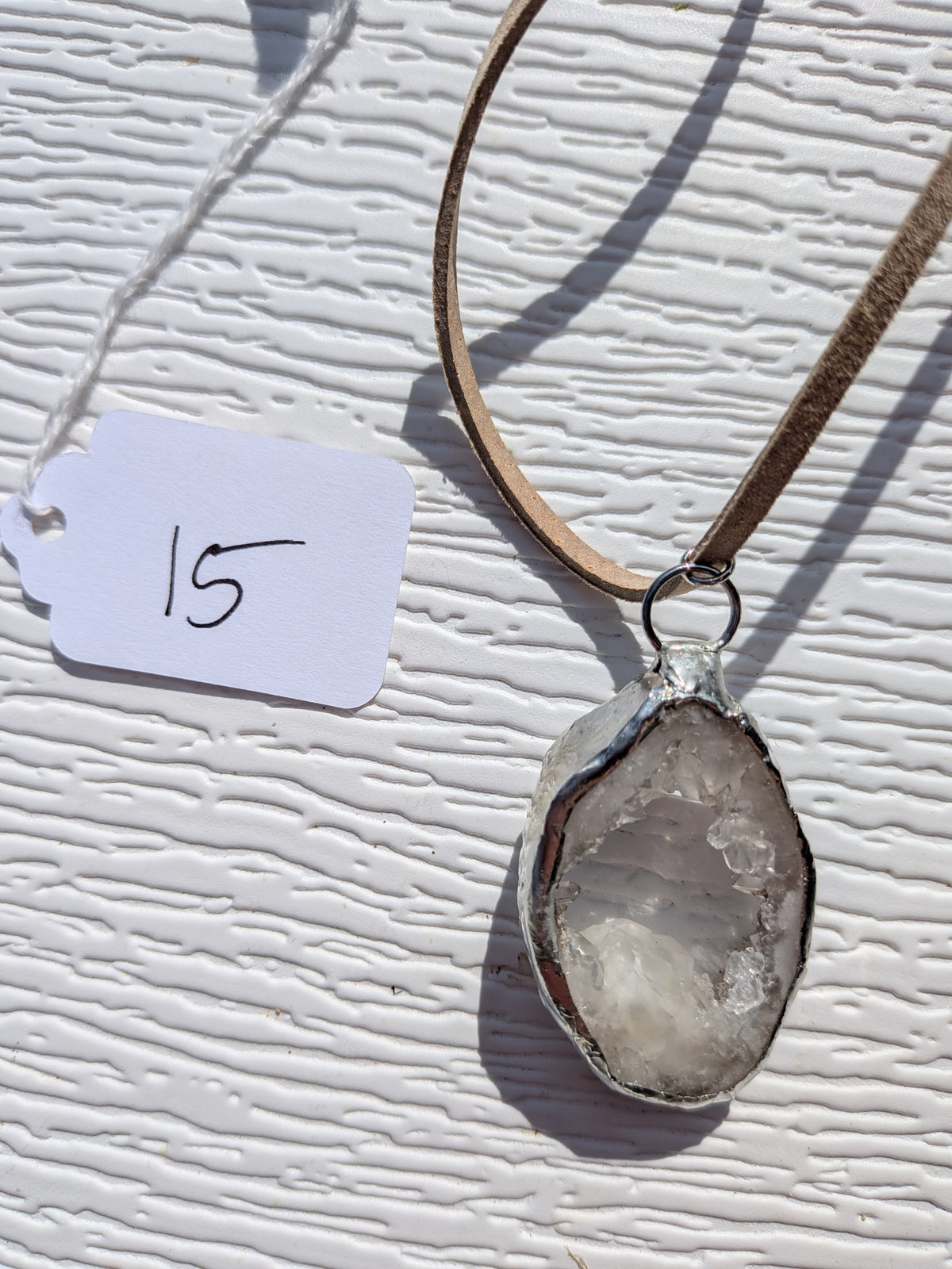 Back of Crystal Pool necklace No. 015, showing the natural stone contours and handmade silver-tone edge.