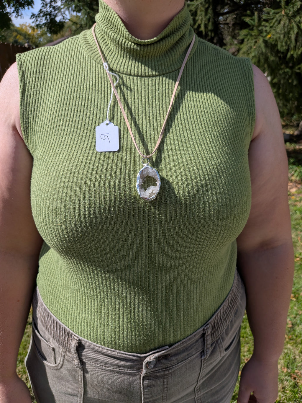 Crystal Pool necklace No. 015 worn on the body, showing the pendant's proportions and tan cord.