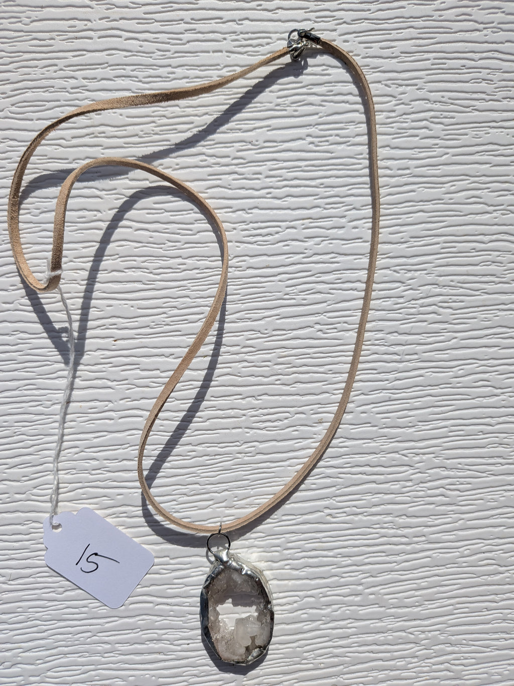 Full Crystal Pool necklace No. 015, showing the pendant, tan cord, and clasp.