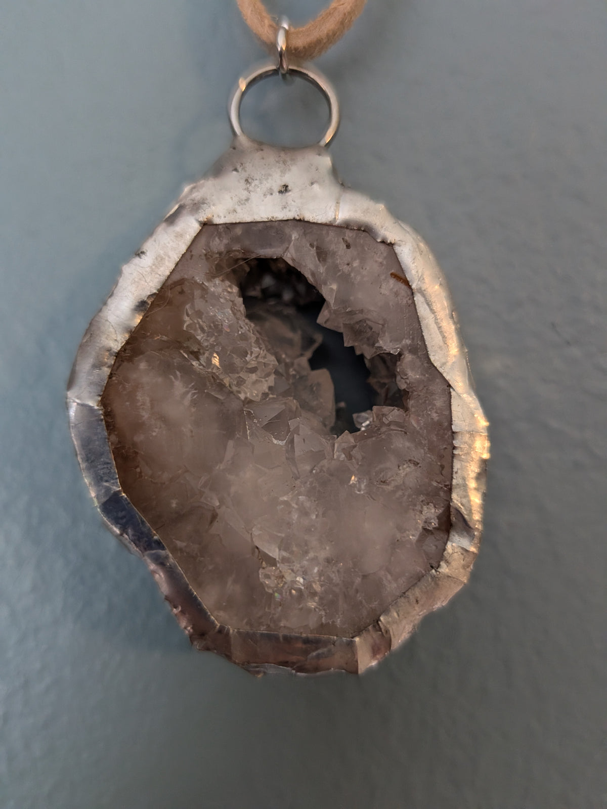 Necklace No. 017: front close-up of the white geode, natural stone detail and handmade silver-tone edging.