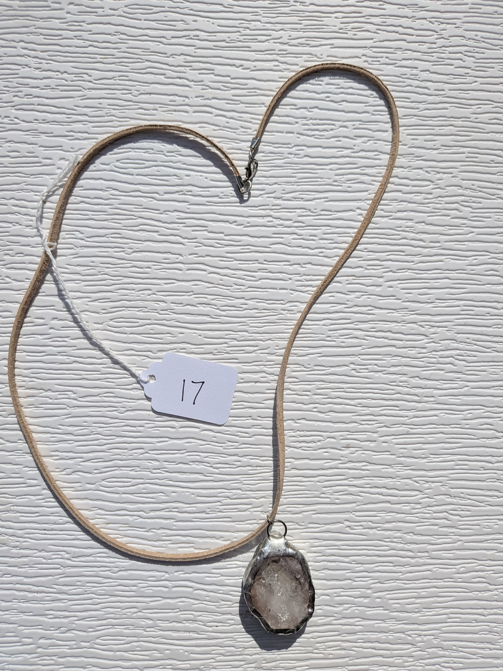 Full Smoky Frost necklace No. 017, showing the pendant, tan cord, and clasp.