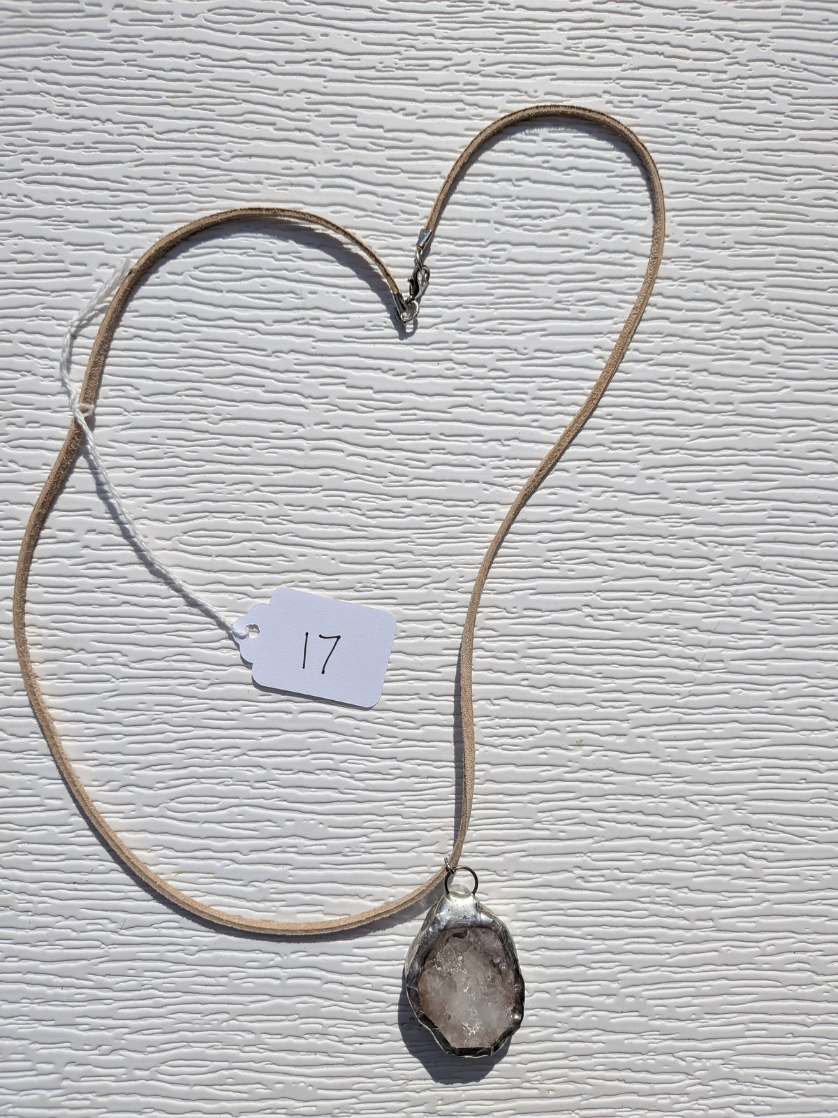 Full Smoky Frost necklace No. 017, showing the pendant, tan cord, and clasp.