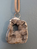 Necklace No. 018: front close-up of the white geode, natural stone detail and handmade silver-tone edging.