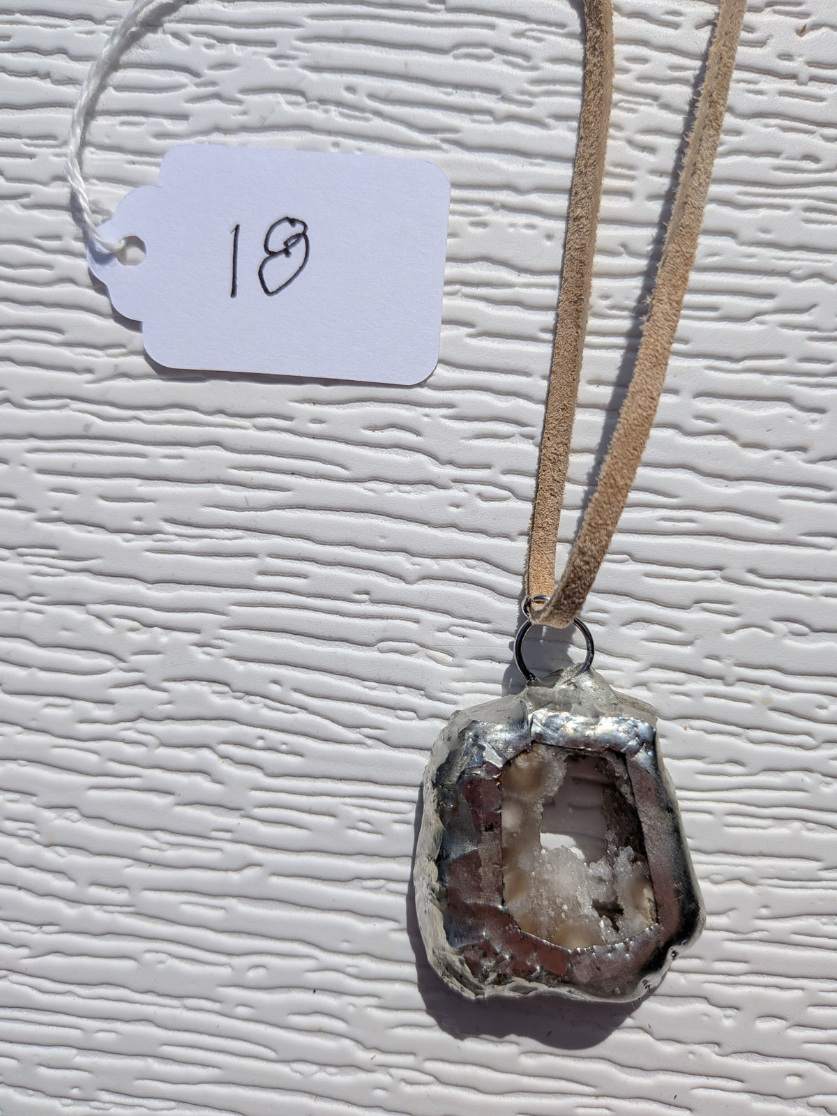 Back of Crystal Grotto necklace No. 018, showing the natural stone contours and handmade silver-tone edge.