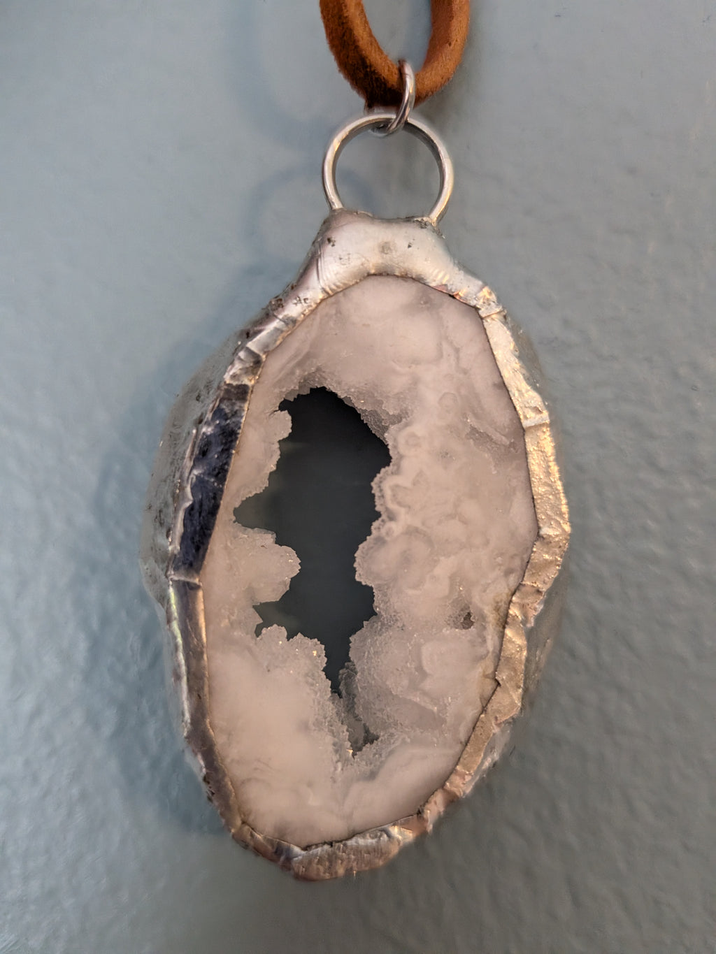 Necklace No. 020: front close-up of the white geode, natural stone detail and handmade silver-tone edging.