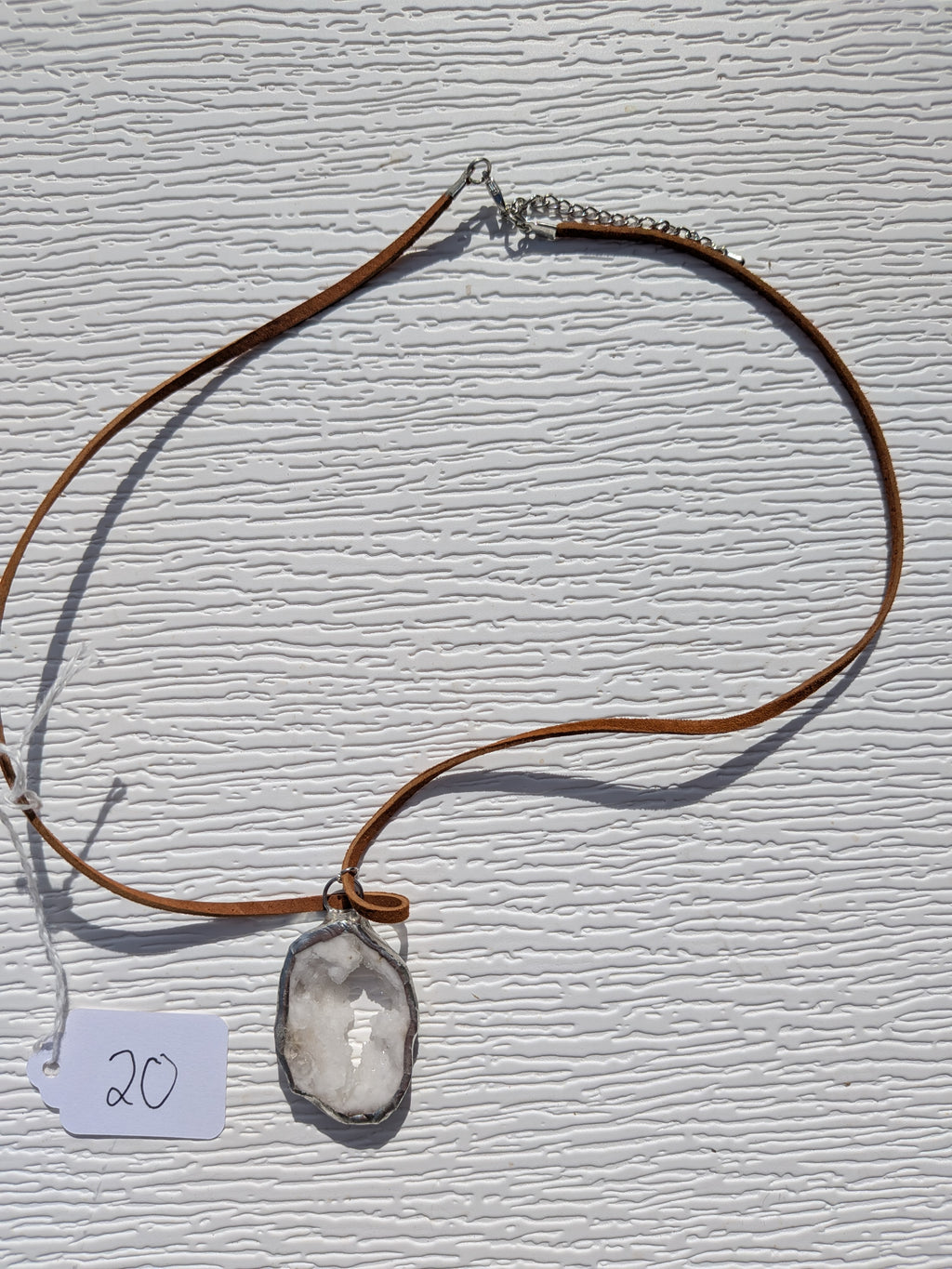 Full Snowlight Window necklace No. 020, showing the pendant, warm brown cord, and clasp.