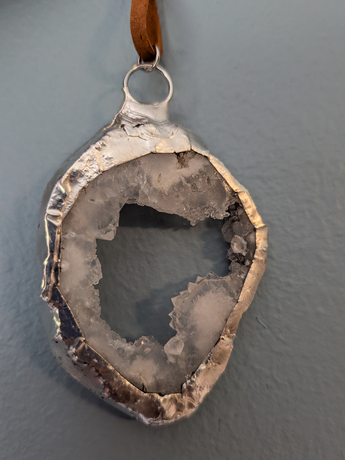 Necklace No. 003: front close-up of the white geode, natural stone detail and handmade silver-tone edging.