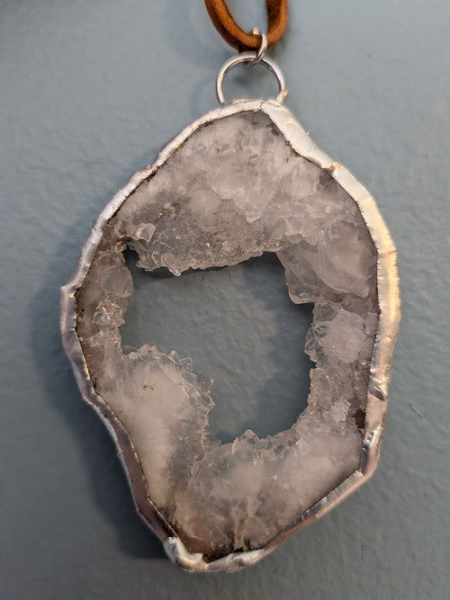 Necklace No. 003: reverse close-up of the white geode, natural stone detail and handmade silver-tone edging.