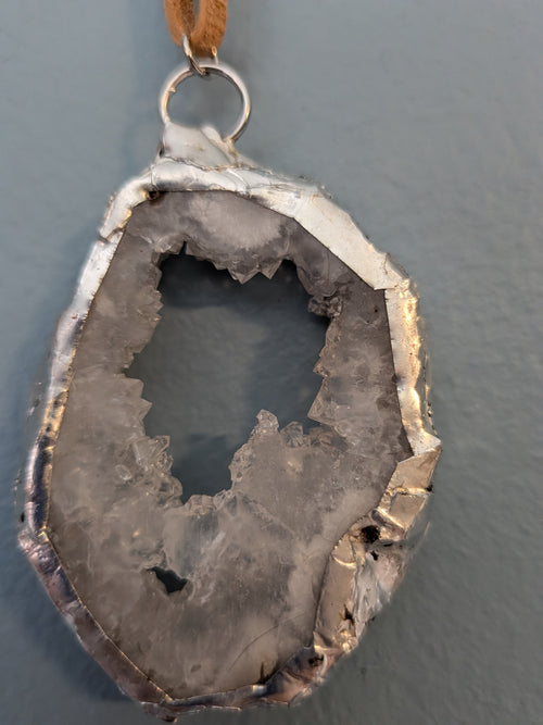 Necklace No. 004: reverse close-up of the white geode, natural stone detail and handmade silver-tone edging.
