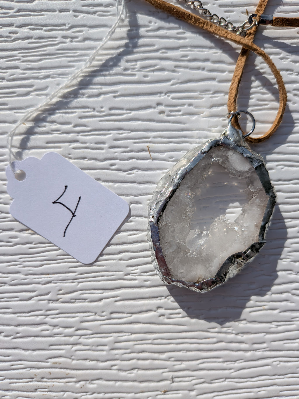 Back of Frosted Halo geode necklace No. 004, showing the natural stone contours and handmade silver-tone edge.