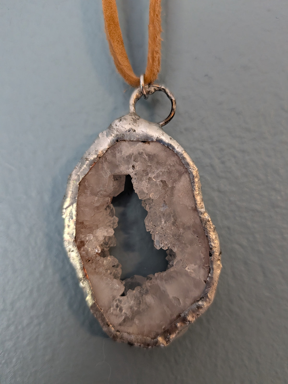 Necklace No. 005: reverse close-up of the white geode, natural stone detail and handmade silver-tone edging.
