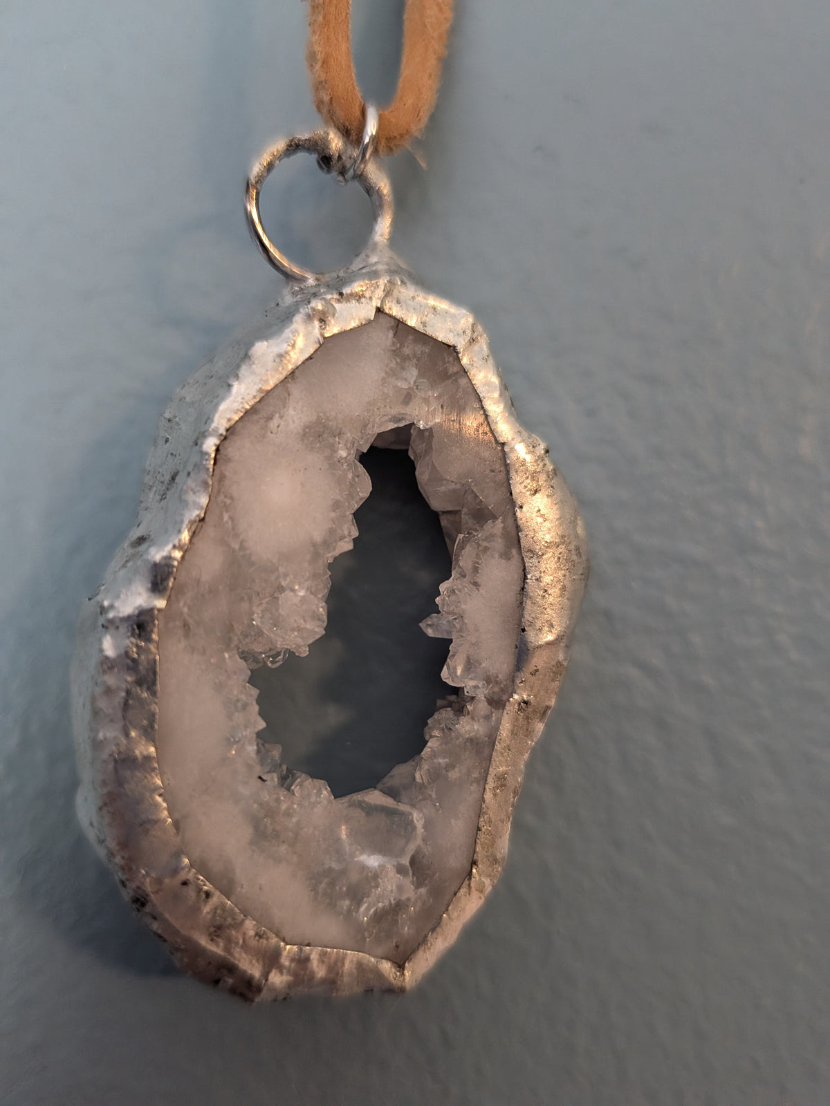 Necklace No. 005: front close-up of the white geode, natural stone detail and handmade silver-tone edging.