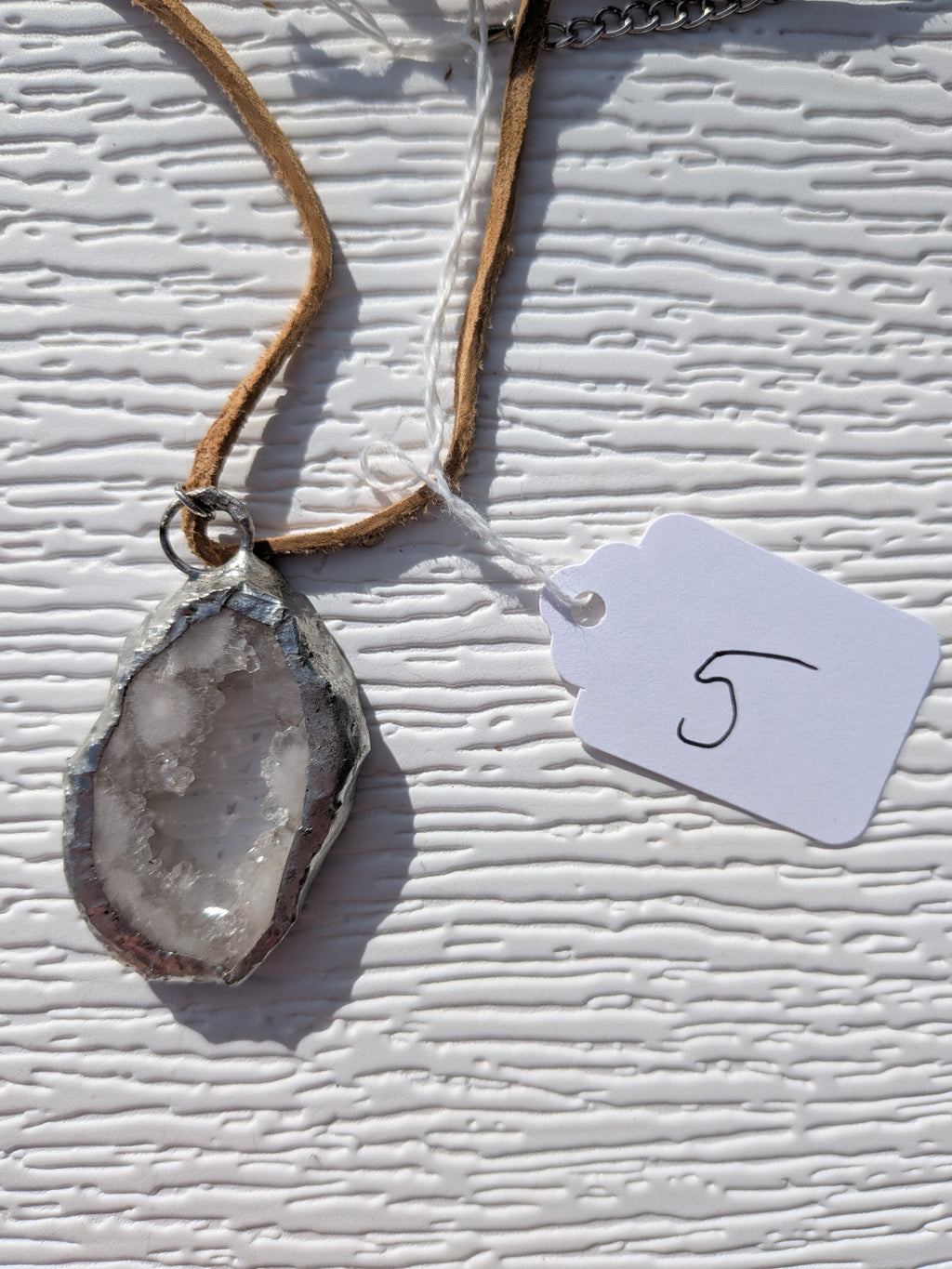 Back of Dewdrop Window geode necklace No. 005, showing the natural stone contours and handmade silver-tone edge.