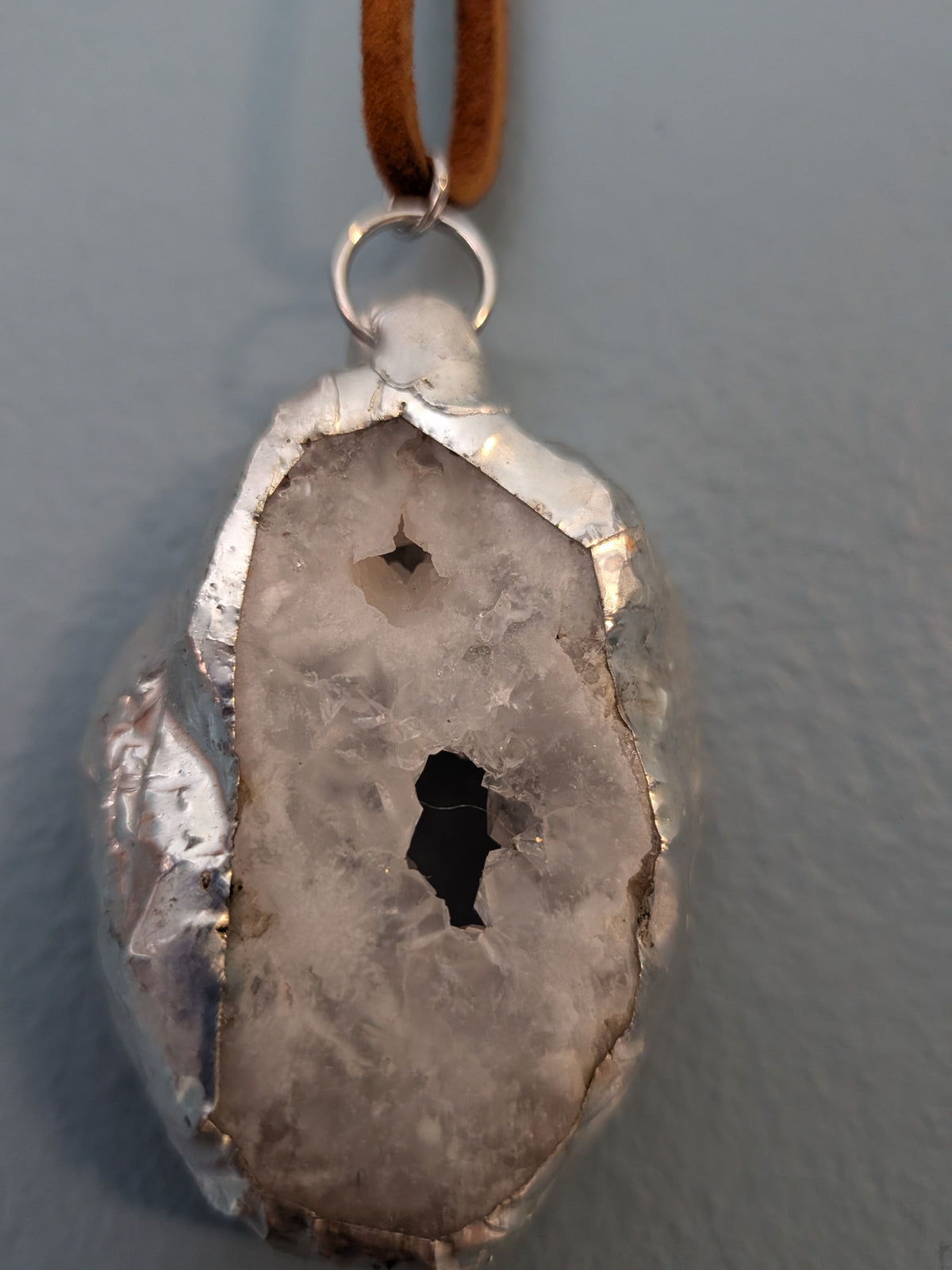 Necklace No. 006: reverse close-up of the white geode, natural stone detail and handmade silver-tone edging.