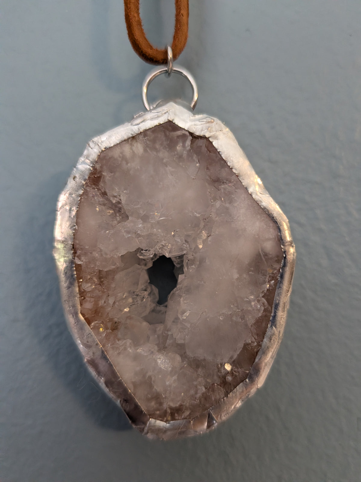 Necklace No. 006: front close-up of the white geode, natural stone detail and handmade silver-tone edging.
