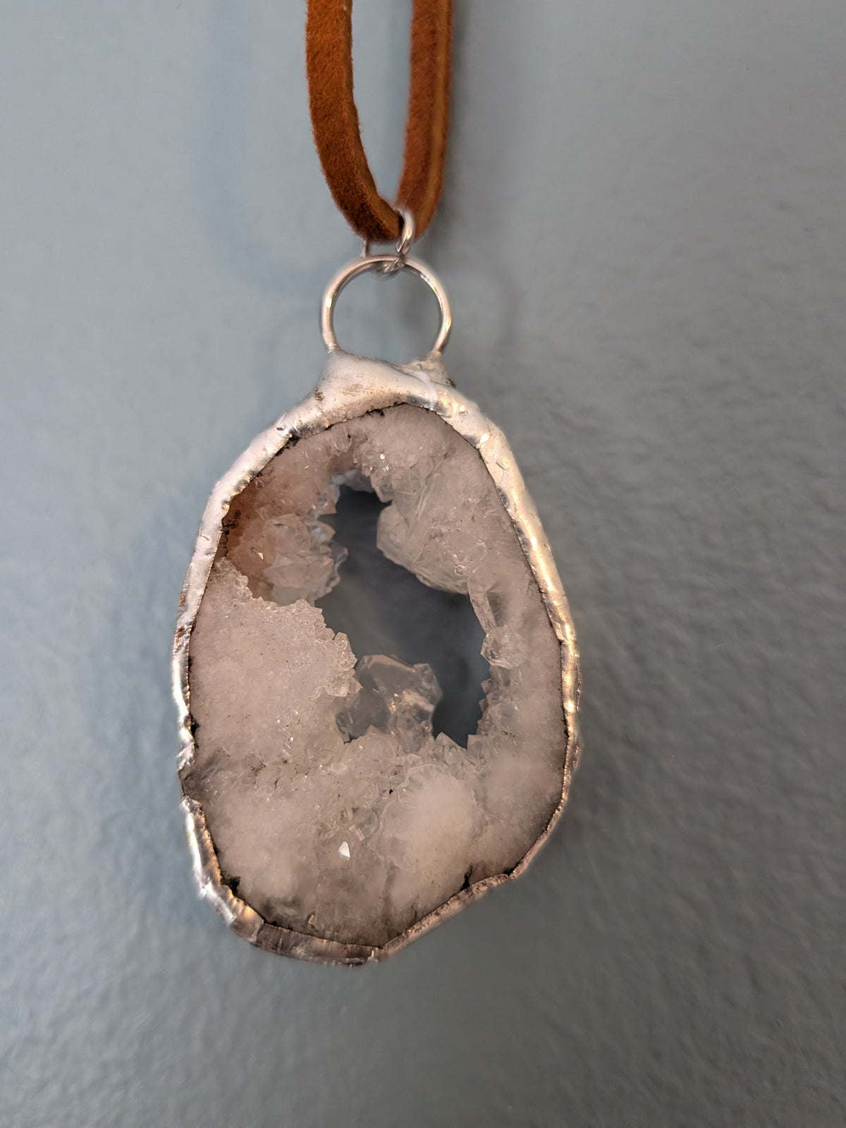 Necklace No. 008: front close-up of the white geode, natural stone detail and handmade silver-tone edging.