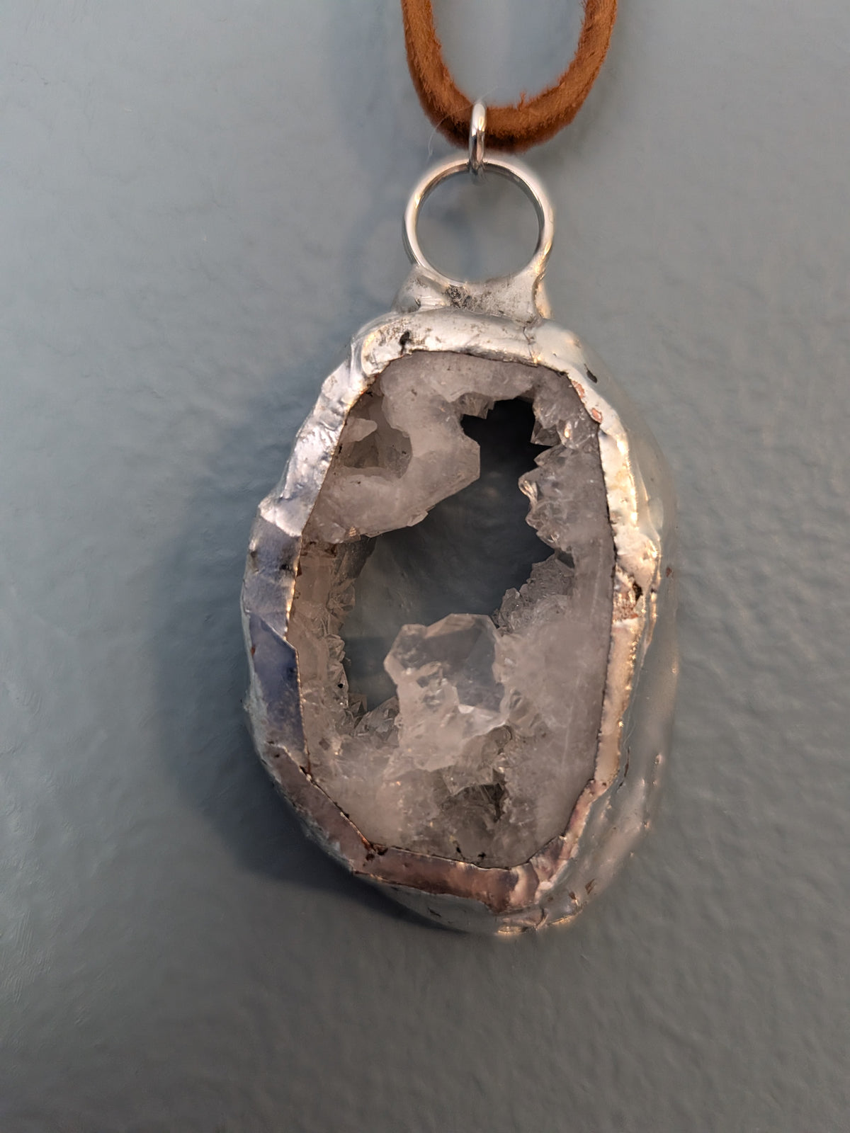 Necklace No. 008: reverse close-up of the white geode, natural stone detail and handmade silver-tone edging.