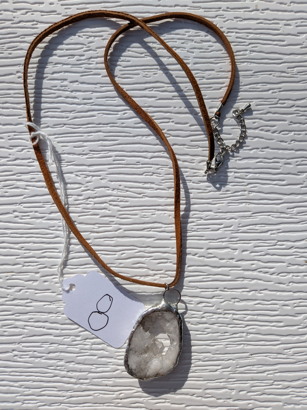 Full Little Crystal Window geode necklace No. 008, showing the pendant, brown cord, and clasp.