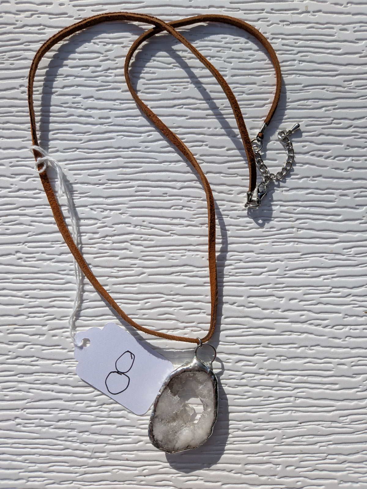 Full Little Crystal Window geode necklace No. 008, showing the pendant, brown cord, and clasp.