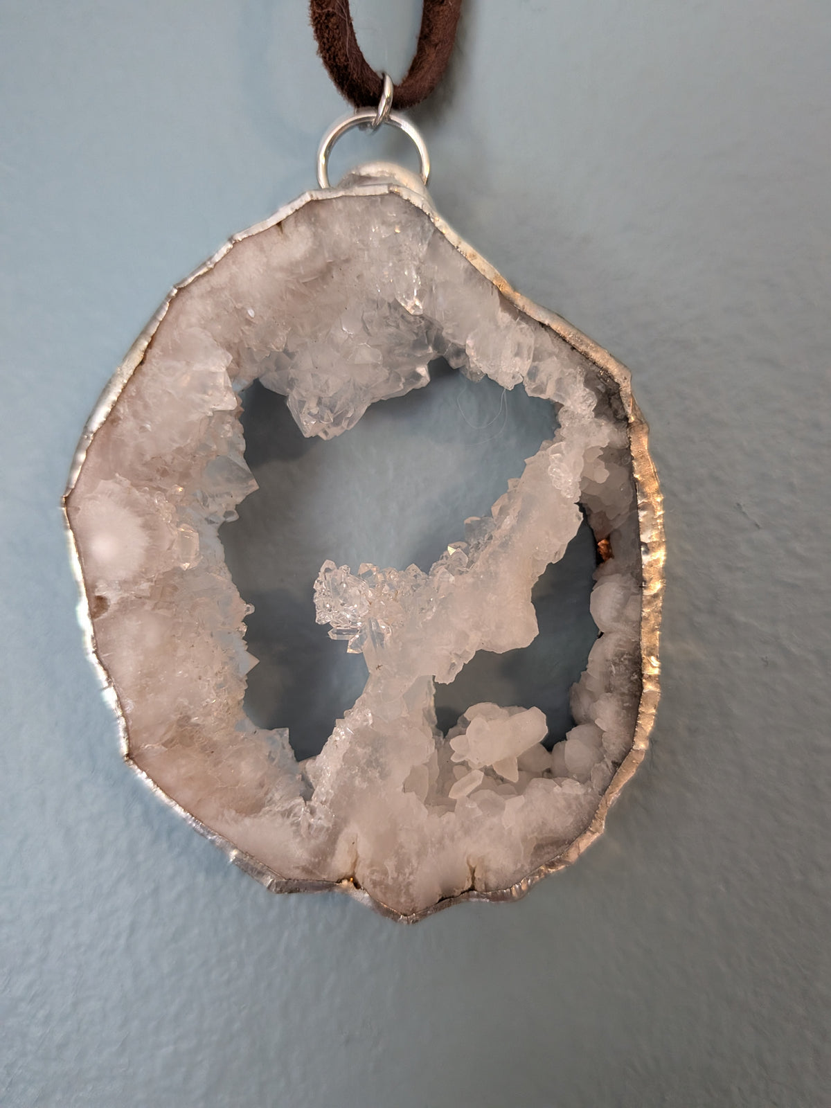 Necklace No. 009: front close-up of the white geode, natural stone detail and handmade silver-tone edging.